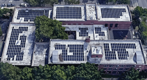 Solar panel installation in progress on a public-building roof
