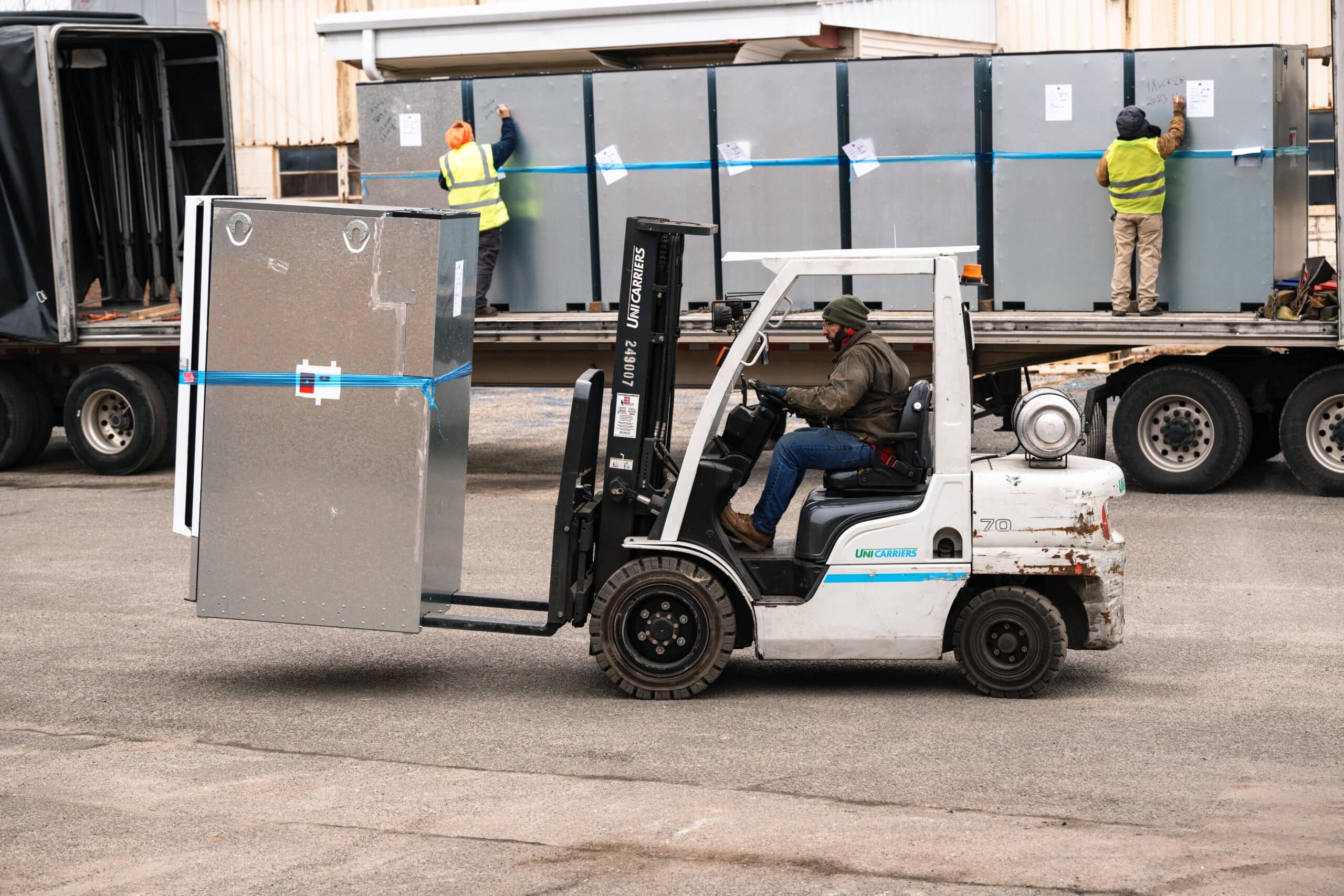T2G crew loading equipment onto a flatbed truck