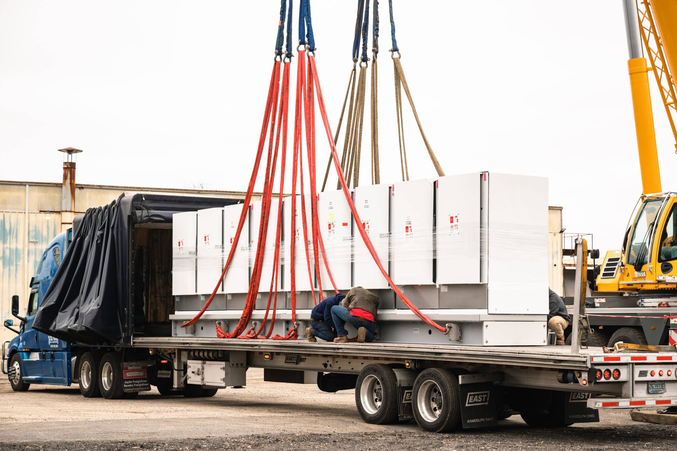 T2G crew loading switchgear onto a flatbed at the Vineland yard
